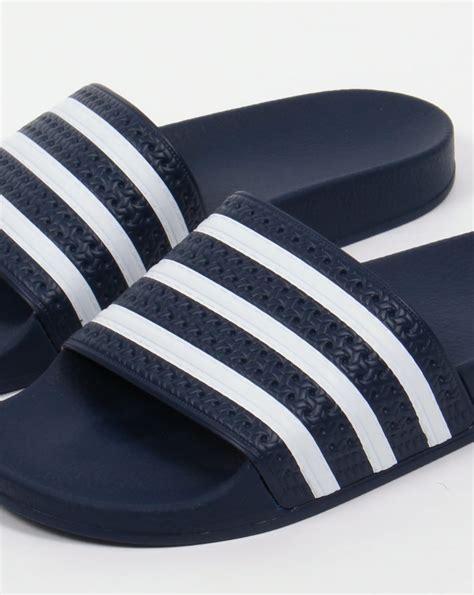 navy adidas slides.